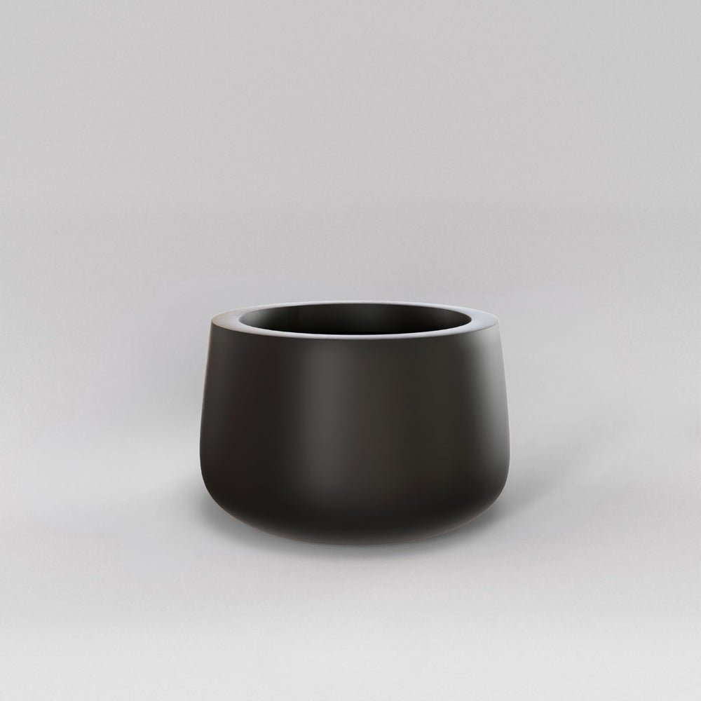 Short Hayden Tapered Round Fiberglass Planter in matte black against gray background.