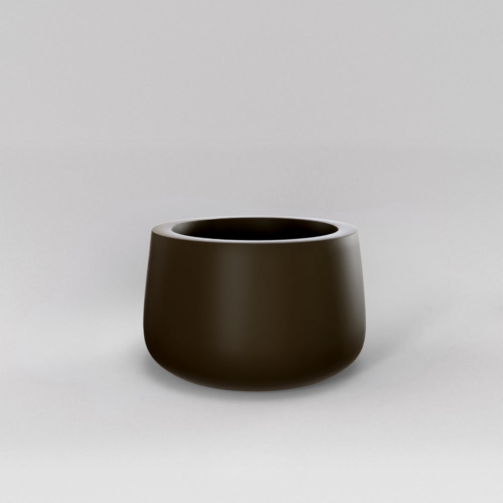 Short Hayden Tapered Round Fiberglass Planter in matte bronze against gray background.