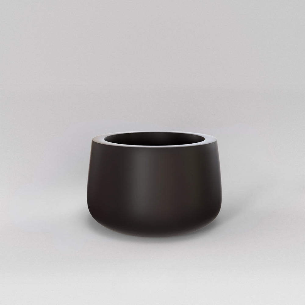 Short Hayden Tapered Round Fiberglass Planter in matte charcoal against gray background.