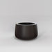 Short Hayden Tapered Round Fiberglass Planter in matte charcoal against gray background.