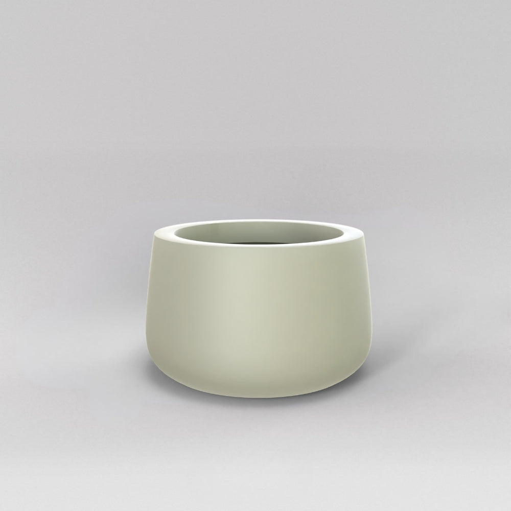 Short Hayden Tapered Round Fiberglass Planter in satin beige against gray background.