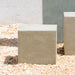 Short Square Textured Pedestal on gravel in the backyard