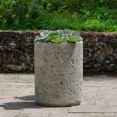 Siros Planter on concrete filled with plants