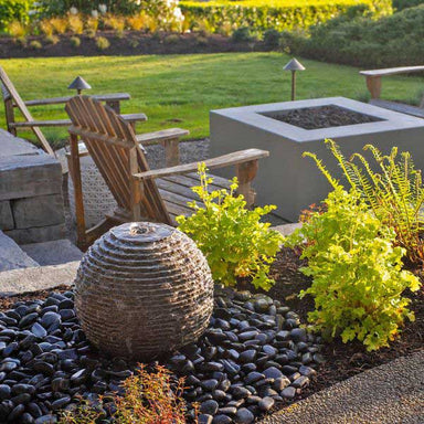 Small Ribbed Sphere Granite Fountain Kit in action in the backyard