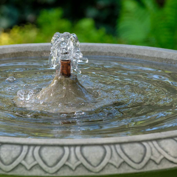 Soane Fountain on grass in the backyard upclose