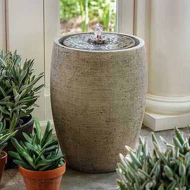 Soma Medallion Fountain on concrete beside cactus