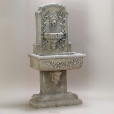Sorrentine Wall Fountain against brown background.