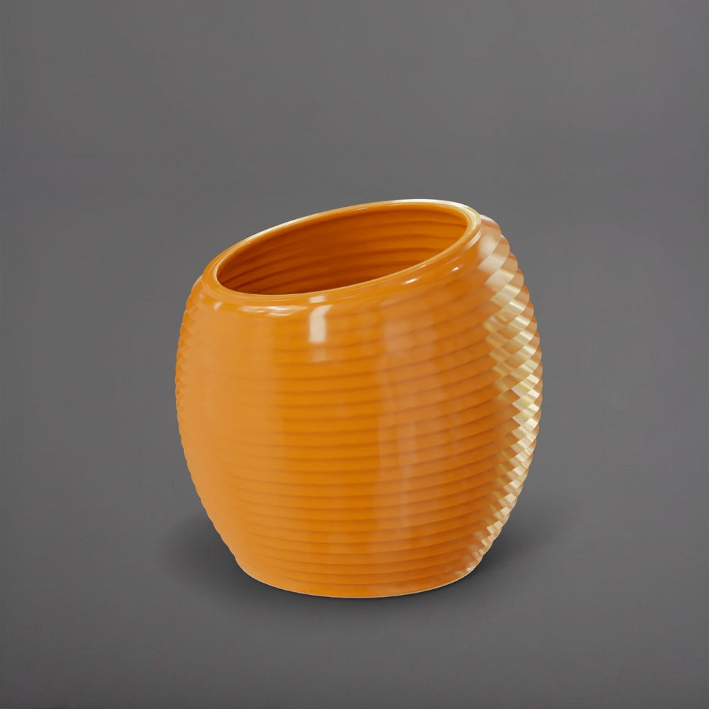 Spiral Globe Fiberglass Planter in gloss tangerine against gray background.