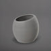 Spiral Globe Fiberglass Planter in matte cement grey against gray background.