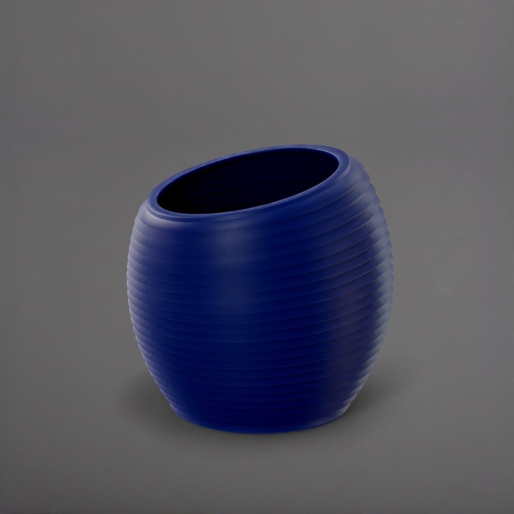 Spiral Globe Fiberglass Planter in matte cobalt blue against gray background.