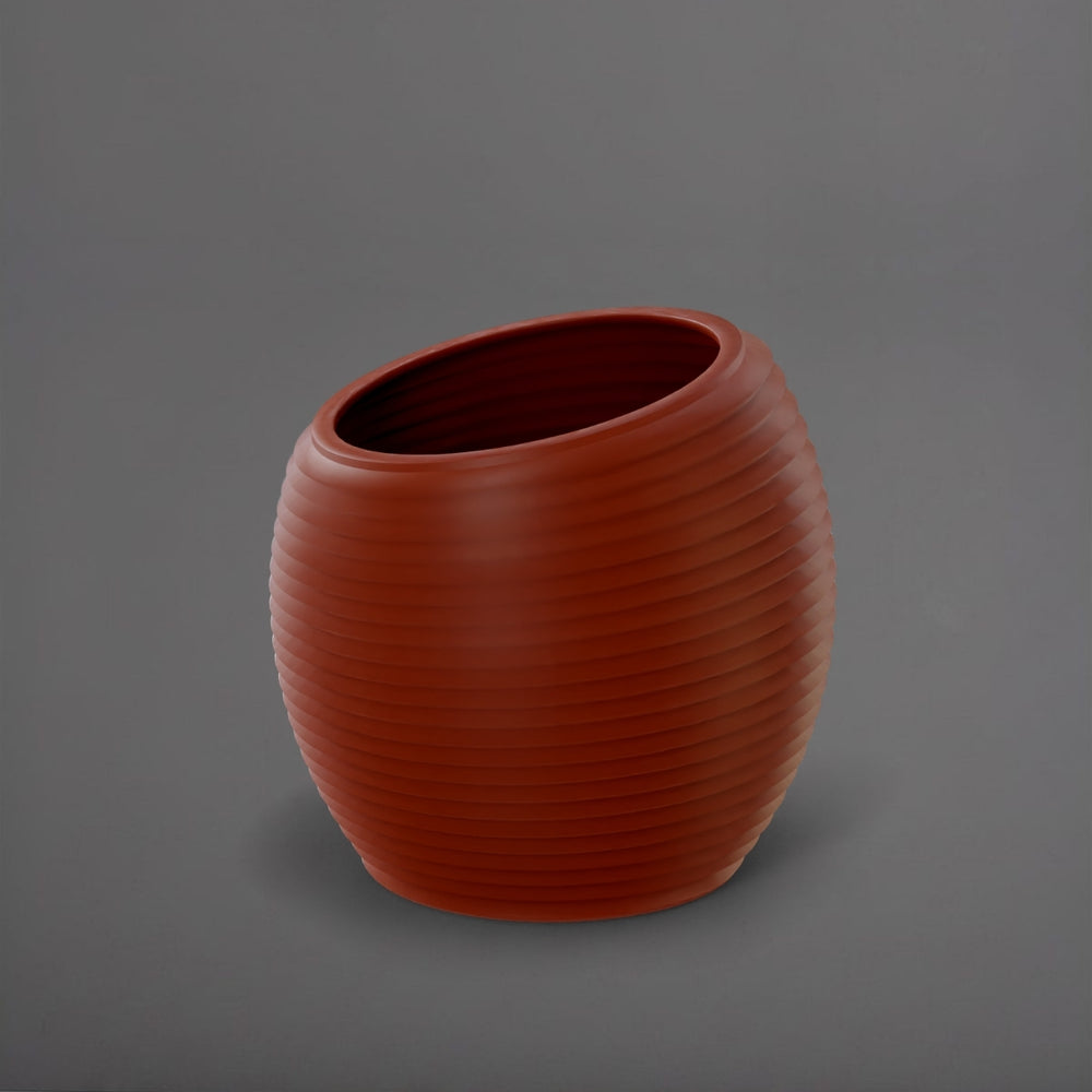 Spiral Globe Fiberglass Planter in matte terra cotta against gray background.