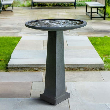 Spire Birdbath on concrete patio.