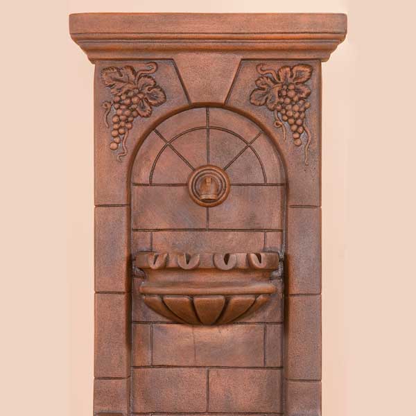 St . Helena Fountain with base concrete spout against brown background upclose.