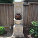 St. Helena Urn Fountain in action against wooden fence.