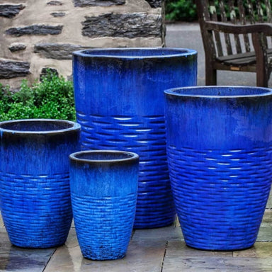 Tall Hyphen Planter - Riviera Blue - S/4 on concrete in the backyard.