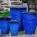 Tall Hyphen Planter - Riviera Blue - S/4 on concrete in the backyard.