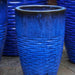 Tall Hyphen Planter - Riviera Blue - S/4 on concrete patio up close.