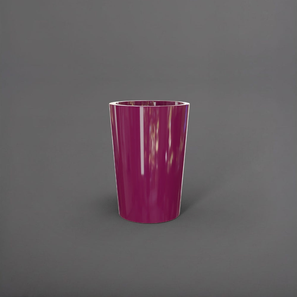 Tagel Tapered Round Fiberglass Planter in gloss eggplant against gray background.