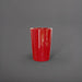 Tagel Tapered Round Fiberglass Planter in gloss red against gray background.