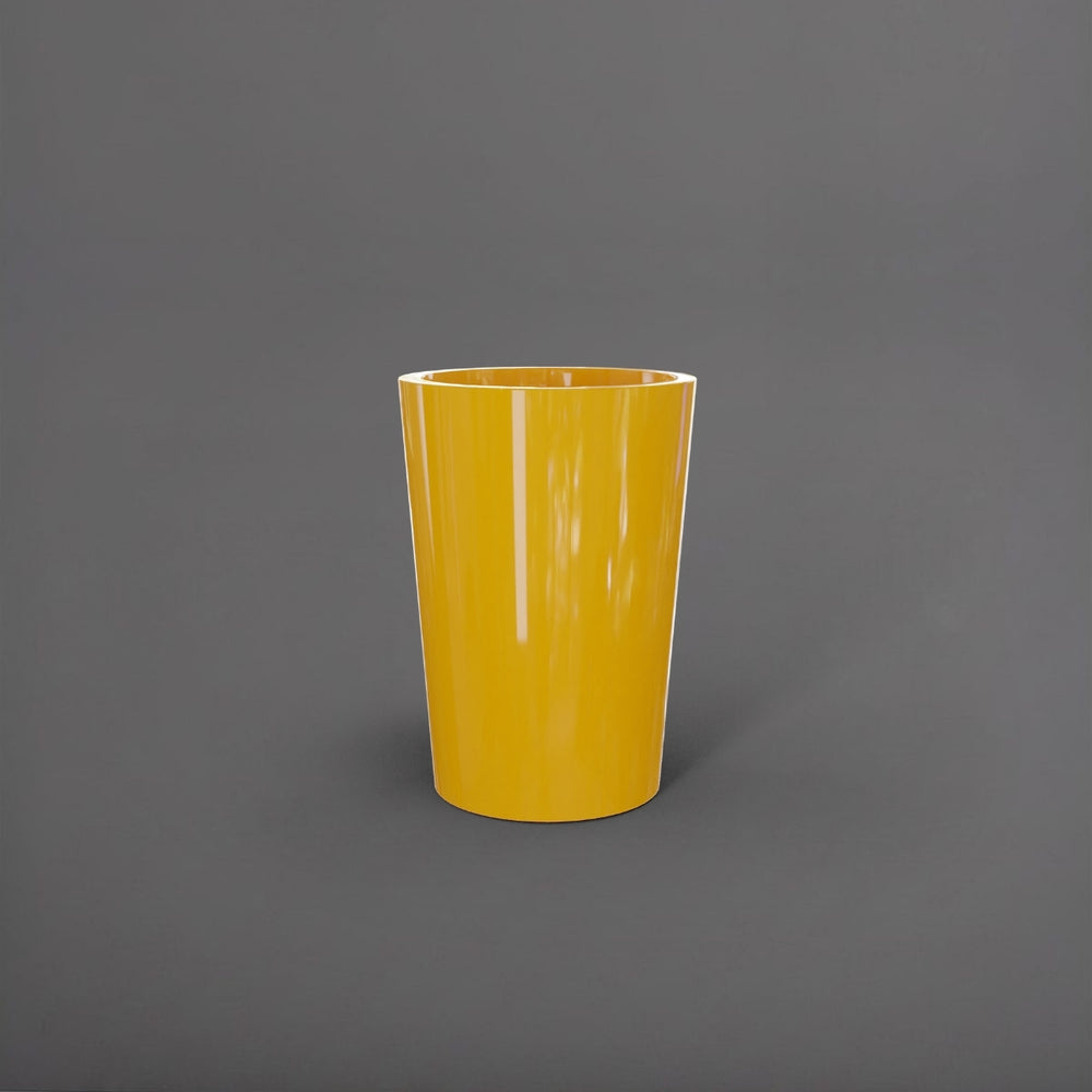 Tagel Tapered Round Fiberglass Planter in gloss saffron against gray background.