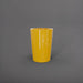 Tagel Tapered Round Fiberglass Planter in gloss saffron against gray background.