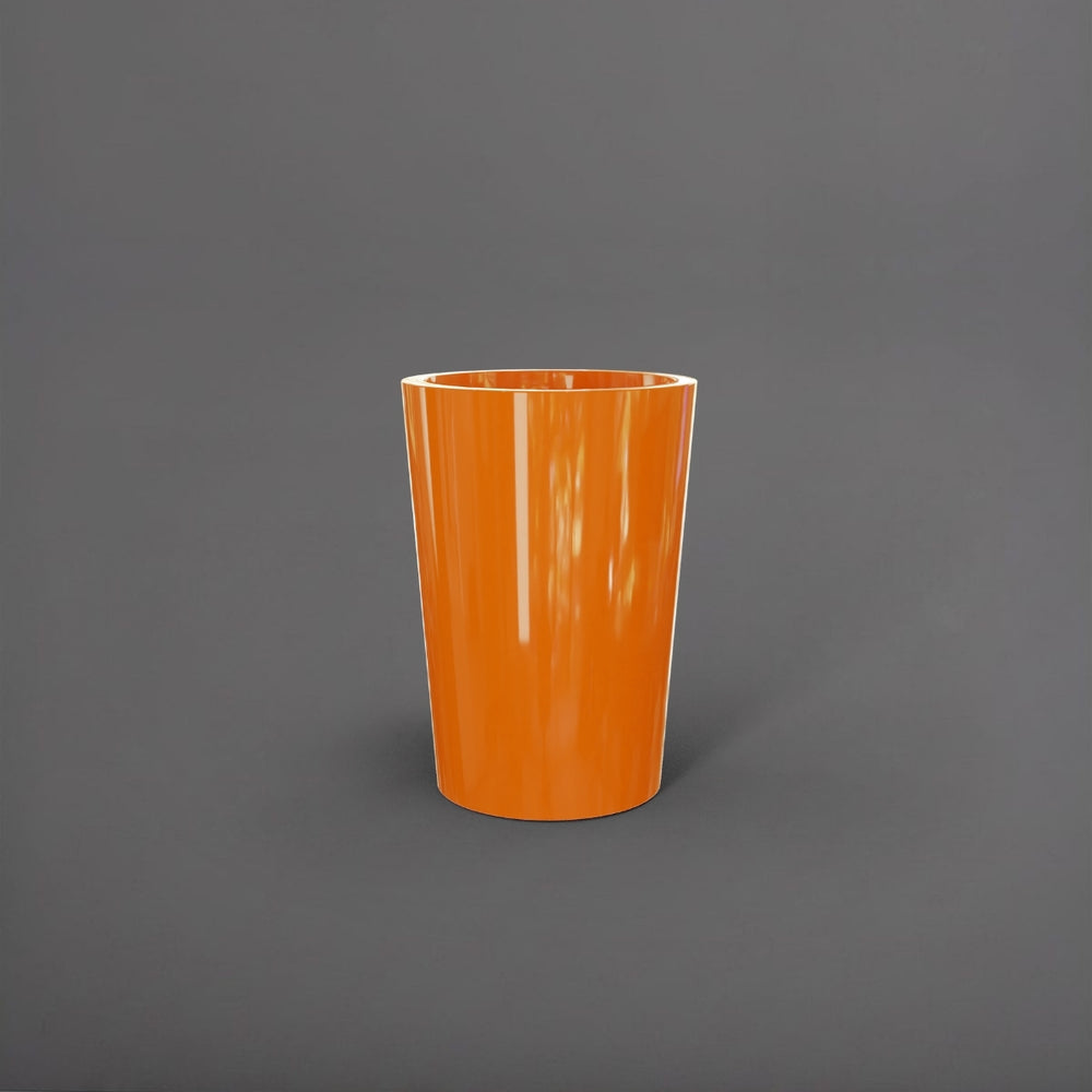 Tagel Tapered Round Fiberglass Planter in gloss tangerine against gray background.