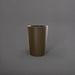 Tagel Tapered Round Fiberglass Planter in matte bronze against gray background.