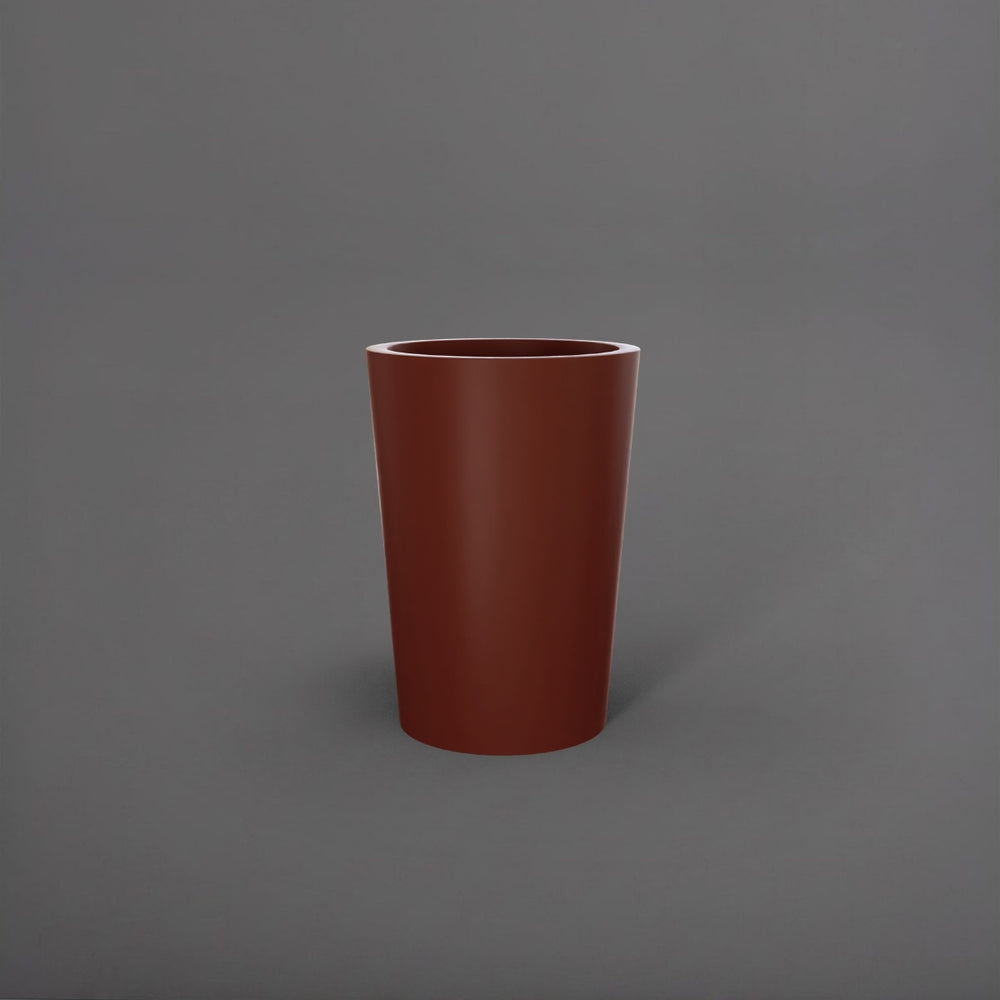 Tagel Tapered Round Fiberglass Planter in matte terra cotta against gray background.