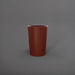 Tagel Tapered Round Fiberglass Planter in matte terra cotta against gray background.