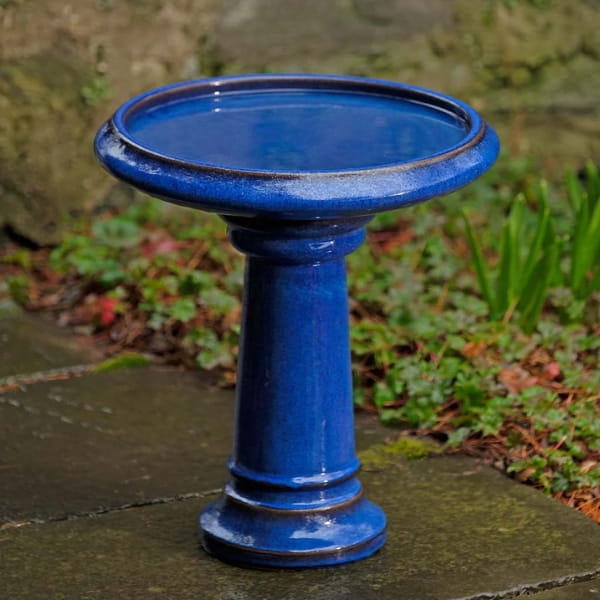 Terrace Birdbath in riviera blue on concrete in the backyard