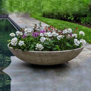 Textured Zen Bowl Planter filled with flowers near swimming pool
