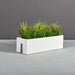 Tiergarden Railing Fiberglass Planter on concrete filled with plants.