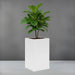 Tolga Corner Fiberglass Planter filled with plants against gray backdrop.