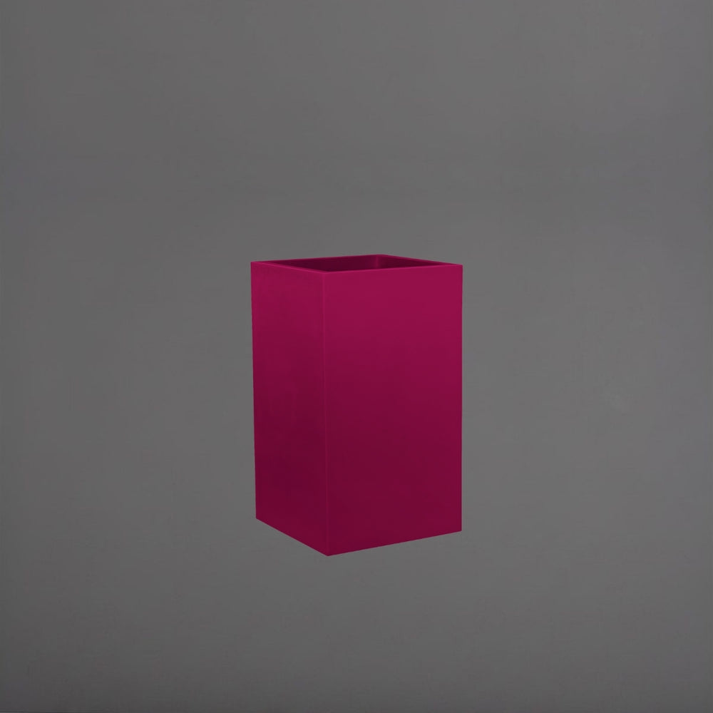 Tolga Corner Fiberglass Planter in gloss eggplant against gray background.