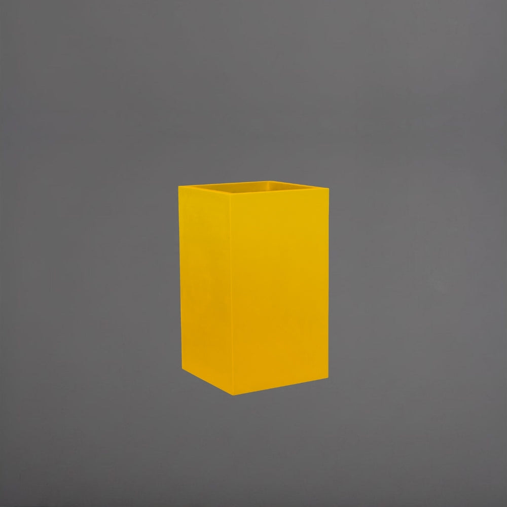 Tolga Corner Fiberglass Planter in gloss saffron against gray background.