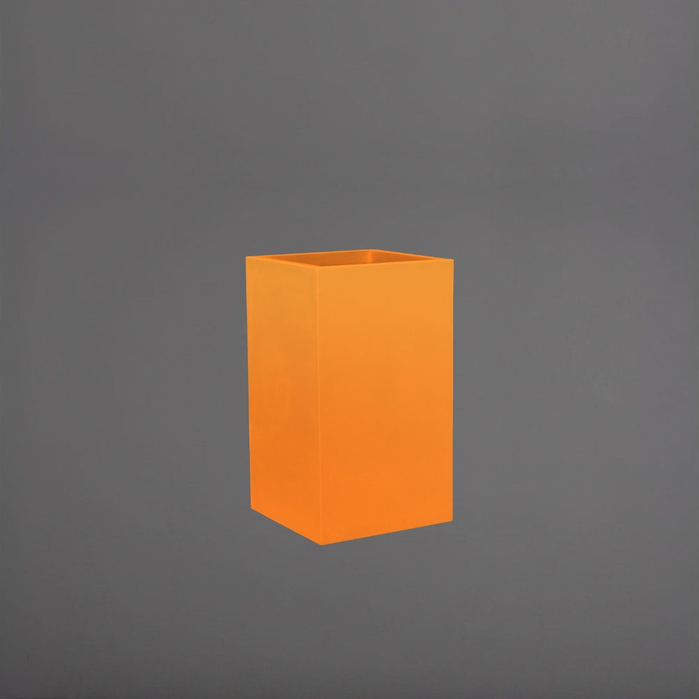 Tolga Corner Fiberglass Planter in gloss tangerine against gray background.