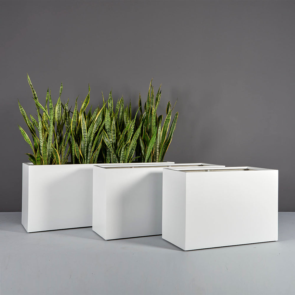 Tolga Rectangle Fiberglass Planter shown with different sizes filled with plants.