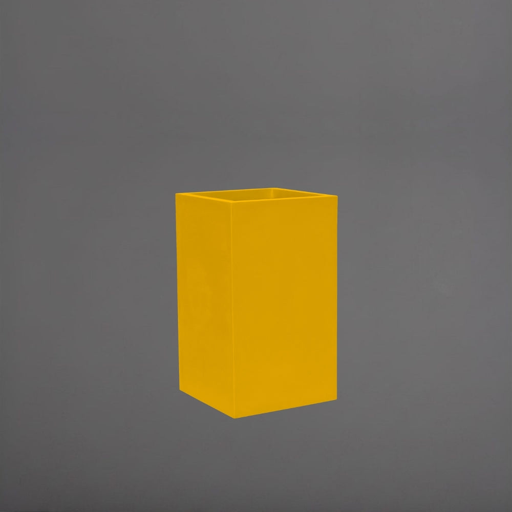 Torino Corner Fiberglass Planter in gloss saffron against gray background.