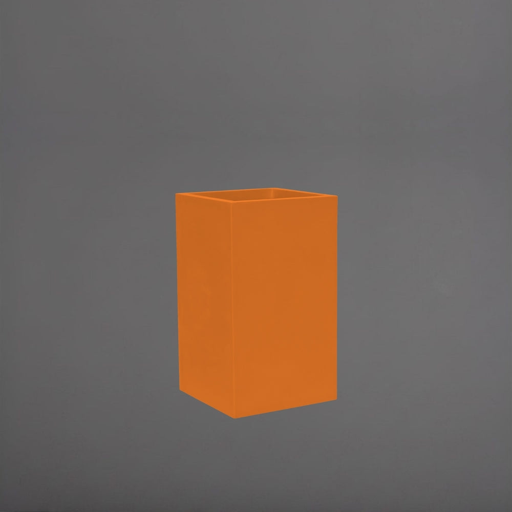 Torino Corner Fiberglass Planter in gloss tangerine against gray background.