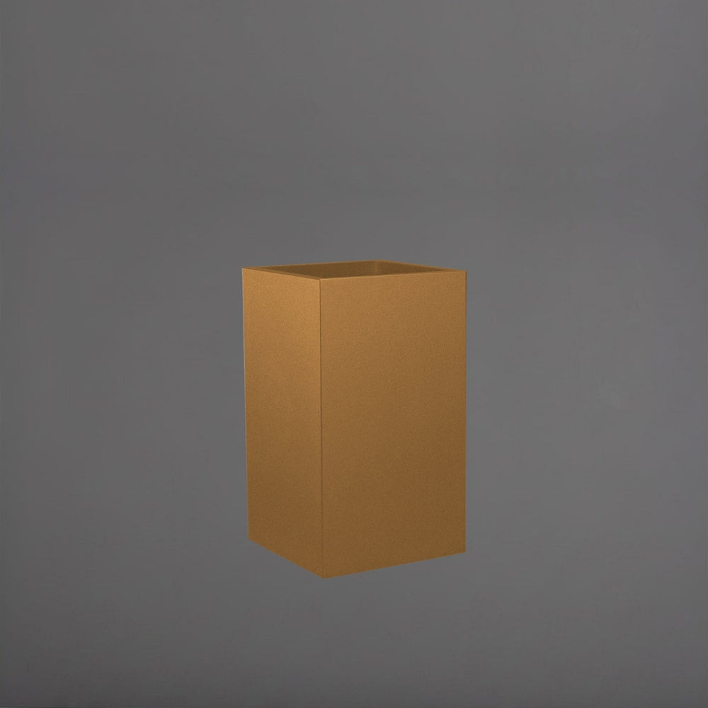 Torino Corner Fiberglass Planter in metallic bronze against gray background.