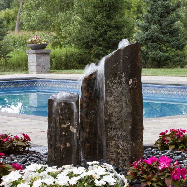 Triple Rustic Basalt Fountain Kit in action near swimming pool