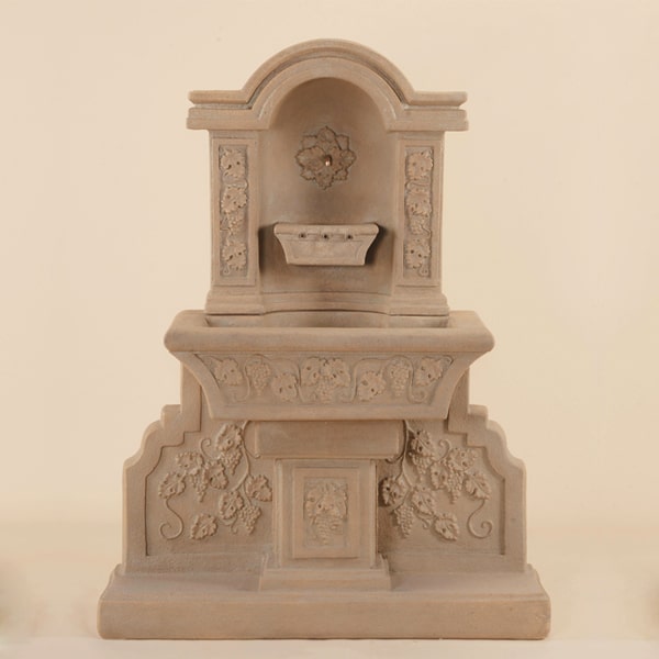 Uva Wall Fountain against brown background.