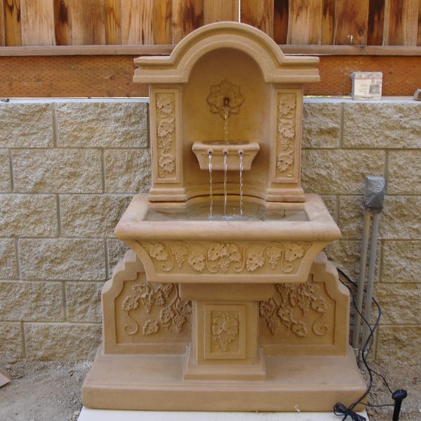 Uva Wall Fountain on concrete in action.