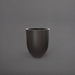 Valencia Tapered Round Fiberglass Planter in matte charcoal against gray background.