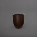 Valencia Tapered Round Fiberglass Planter in matte dark brown against gray background.