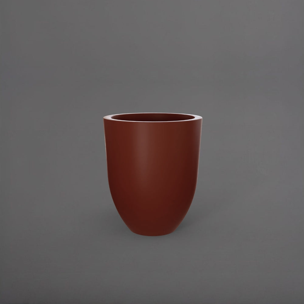 Valencia Tapered Round Fiberglass Planter in matte terra cotta against gray background.