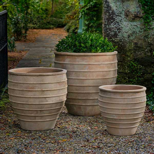 Vari Planter - Antico Terra Cotta - S/3 filled with plants in the backyard