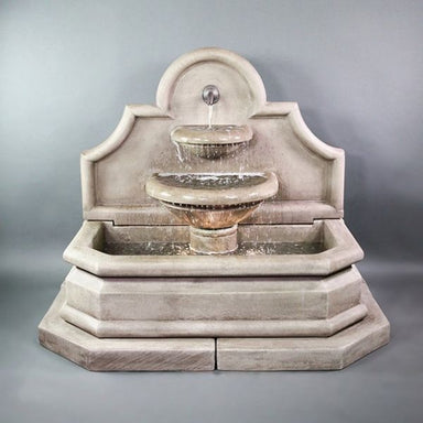 Venasque Wall Fountain against gray background.