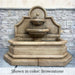 Venasque Wall Fountain in Brownstone color against concrete wall.
