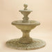 Villa Santini Two Tier Fountain against brown background.